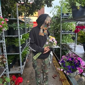 Black hoodie with a few paint marksks on it